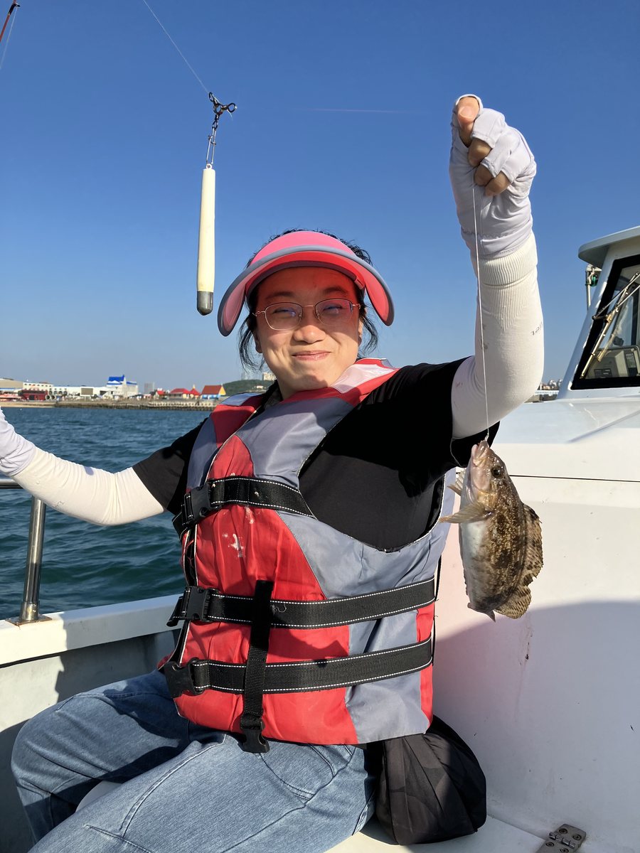 Another black fish held up over the water on the same drift